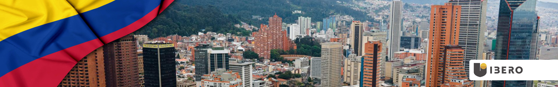 Bandera de Colombia ondeando con edificios de Bogotá