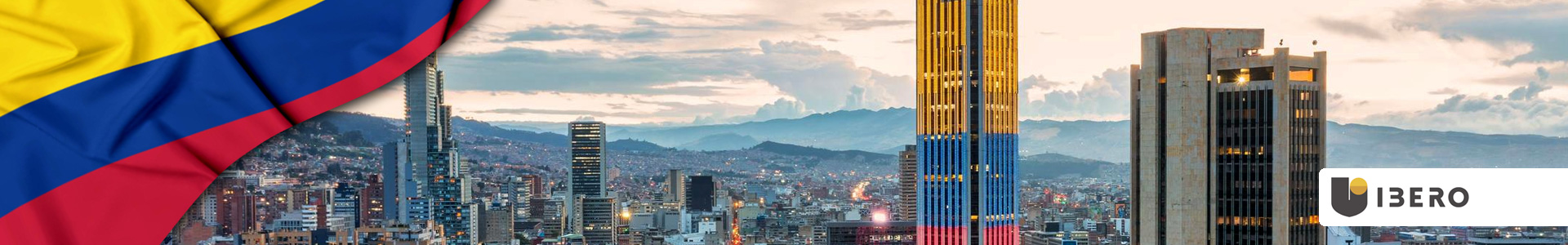 Bandera de Colombia ondeando con vista aérea de Bogotá, edificios altos y luces brillantes