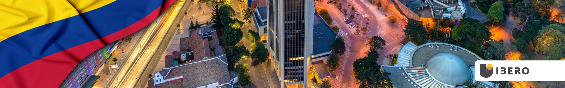 Bandera de Colombia ondeando con vista aérea de Bogotá, sobre edificios y el Planetario