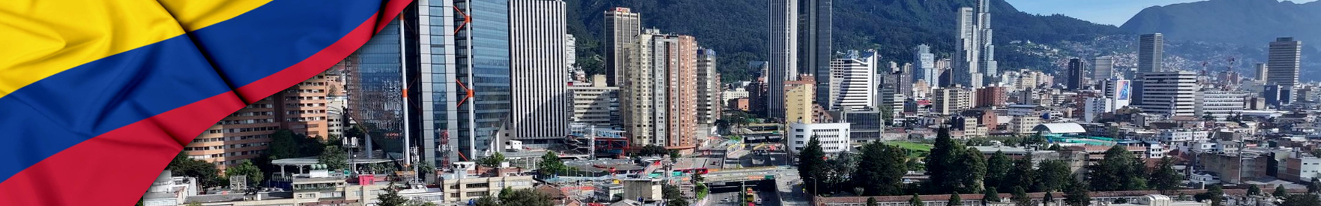 Banner: bandera de Colombia ondeando sobre el horizonte de Bogotá.